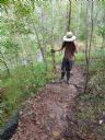 <p>In rocky areas trapping silt can smooth the tread.  Logs on the outslope can act as silt traps while water flows out through stone fill.  In this spot, large springs deliver water free of silt to the trail and a subtle drain is still required