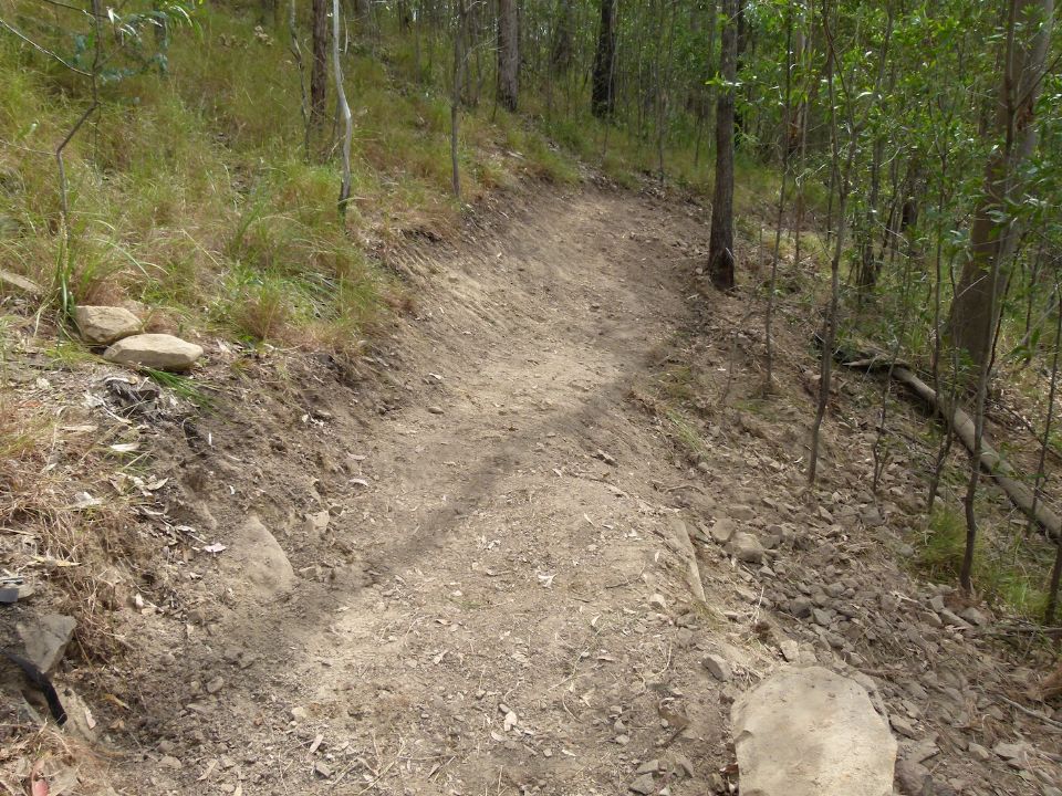 Extending the rock wall and re-shaping the lower half of the berm to follow