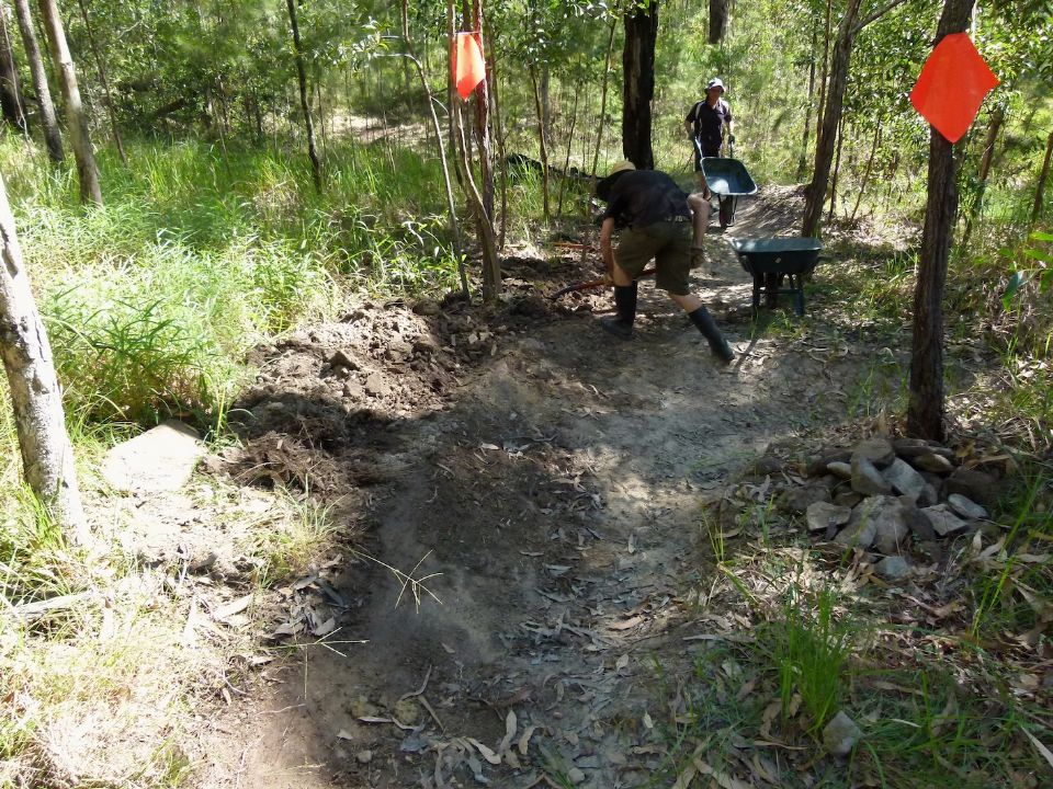 Reducing the height and relaxing this berm and using the soil on the next